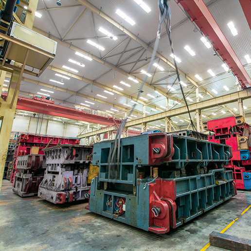 Mold equipment for a car factory in a storage warehouse being lifted by a crane