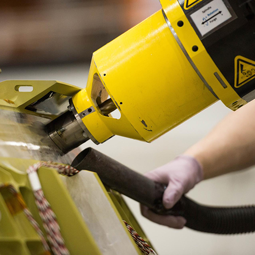 Robot performing friction plug welding operation to fill hole in aluminum alloy