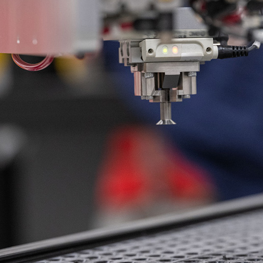 Closeup of grippers holding fastener in fastener handling end effector